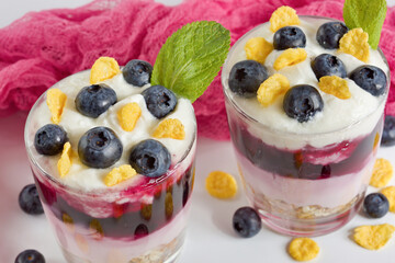 White delicious yogurt dessert with blueberries, granola, cornflakes and jelly. Healthy Breakfast, light snack. Horizontal.