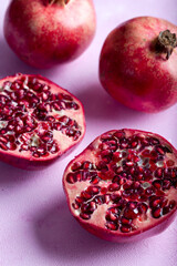 Pomegranates cut open with pomegrante seeds. Fruit minimalism creative concept.  Top view.