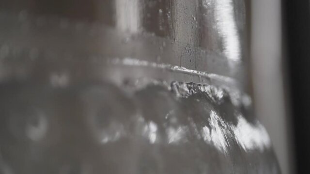 Closeup of Ice on a Chilled Brewery Fermenter reflecting light- 30 fps