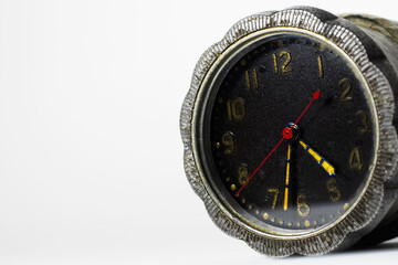 Close-up of vintage alarm clock isolated on white background with copy space.