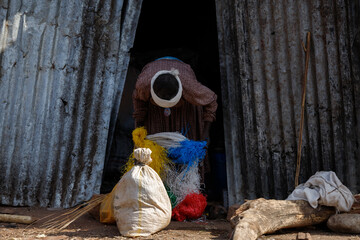 a woman at the door of a building puts bags and closes them