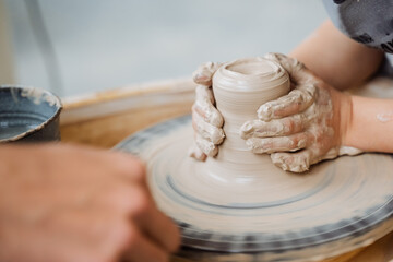 children's hands sculpt clay, sculpt clay, pottery workshop, potter's wheel, white clay in the hands of a child