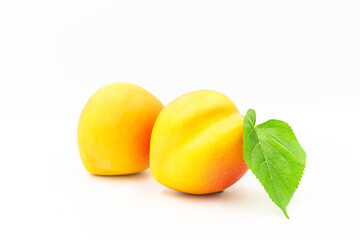 Peach with green leaf isolated on white background