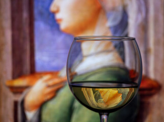 The classic portrait of the old woman by Italian artist Fra Filippo Lippi  (1406-1469) shown as an inverted reflection in a wine goblet.