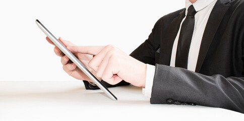 Businessman finger touching screen of a digital tablet at the departure gate of an airport