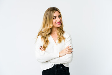 Young caucasian blonde woman smiling confident with crossed arms.