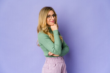 Young caucasian blonde woman smiling happy and confident, touching chin with hand.