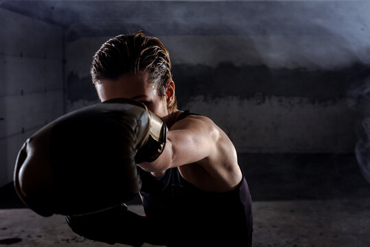 Side view of a silhouette female fighter punching with boxing gloves - Powered by Adobe