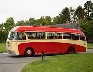 Vintage single deck red bus on the street in the Cotswolds