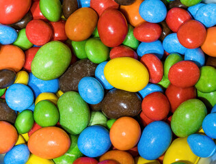Fototapeta na wymiar A series of multi-colored button-shaped chocolates