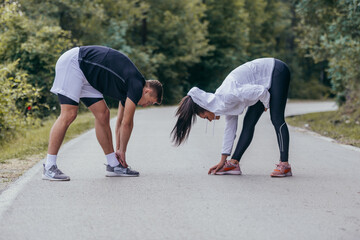 Male and female athletes preparing for a marathon, run, workout. Healthy lifestyle concept.