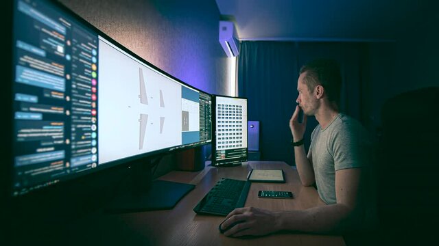 The engineer working on ultra wide screen computer setup