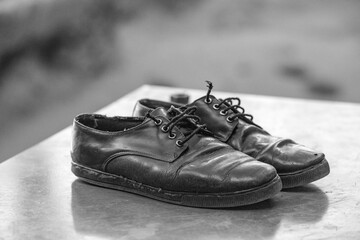 black shoes left outside at the church bench