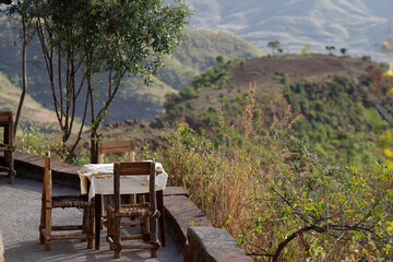 Fototapeta premium a table with chairs placed on the track to open a beautiful view of the landscape