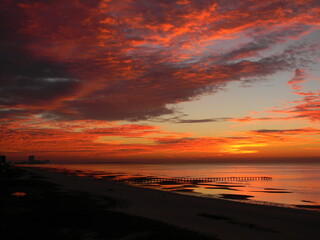 Fototapeta na wymiar Orange Sunrise on the Beach