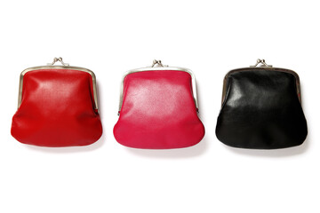 Three old fashioned vintage purses isolated on white background. Red, pink and black leather wallets