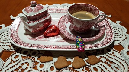 Cup of aromatic black coffee and a sugar bowl on a porcelain tray