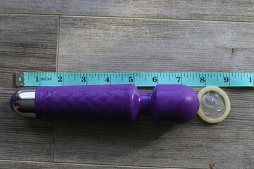 tape measurer next to a 7 inch dildo showing size