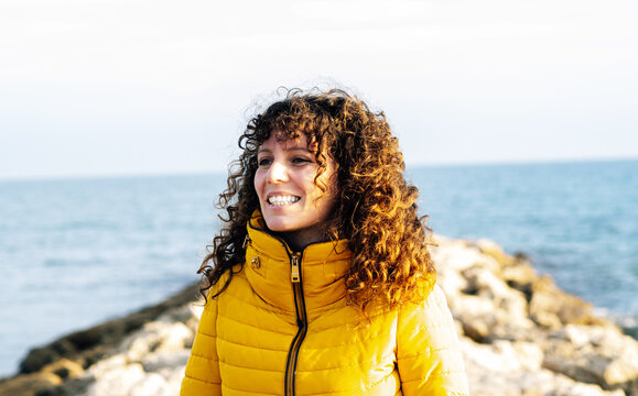 Adventurous Woman Smiling At Sea During Winter