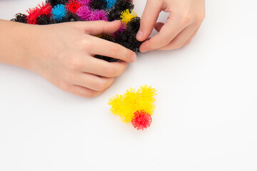 Obraz na płótnie Canvas elements of children's designer of Velcro in kid hands,isolated on white background