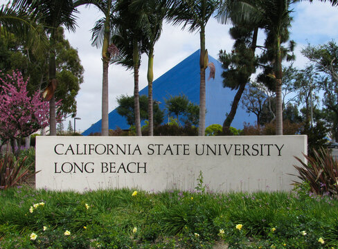 Long Beach, California USA - May 11, 2018: Entrance of California State University Long Beach with sign and a view of the blue Walter Pyramid sports arena.