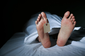 A deceased man's feet and tag
