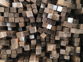 Tips of wooden boards placed in a pattern in a timber warehouse. Wood concept. Tips concept.