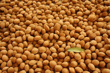 Many almonds with shell and a leaf