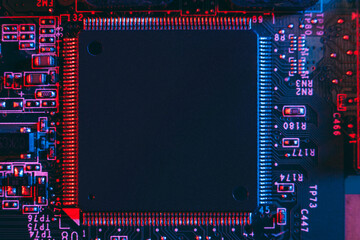 Hardware technology concept in neon light. Motherboard in blue-red light. Computer  component. Dark...