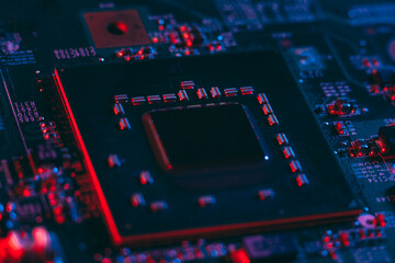 Hardware technology concept in neon light. Motherboard in blue-red light. Computer  component. Dark...