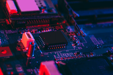 Hardware technology concept in neon light. Motherboard in blue-red light. Computer  component. Dark...
