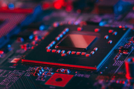 Hardware technology concept in neon light. Motherboard in blue-red light. Computer  component. Dark photo.Neon Colors.GPU processor. CPU