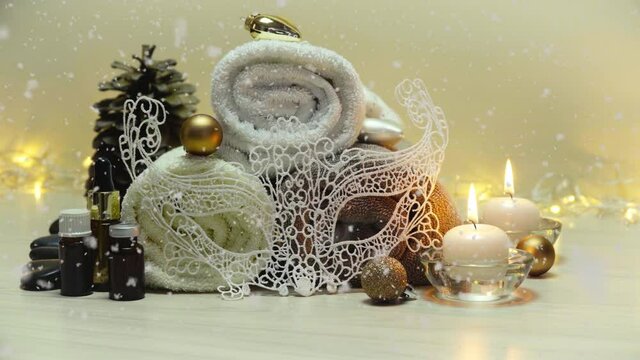 Spa salon items and attributes with christmas decorations in mild snowfall, beautiful christmas landscape with spa elements 4K