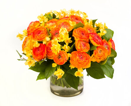 Bouquet of roses and daffodils in a transparent vase