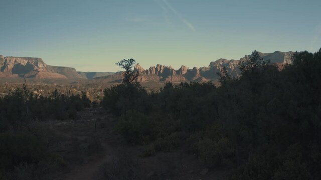 Aerial Drone View of residential areas and roads in Sedona and Oak Creek Canyon in Arizona on a bright and sunny fall day showing unique red rock formations and landscapes 