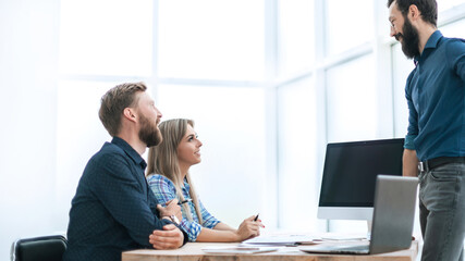 employees discuss something with a visitor to the Agency