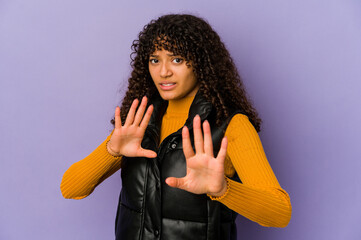 Young african american afro woman isolated rejecting someone showing a gesture of disgust.