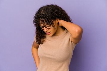 Young african american afro woman isolated having a neck pain due to stress, massaging and touching...