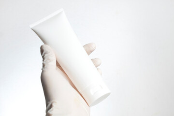 doctor hand with glove holding cosmetic makeup pedestal display showcase stand for cream product with skincare healthcare