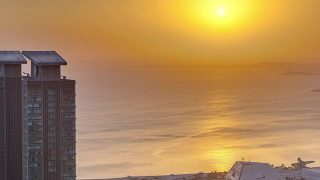The skyline of West Bay and Doha City Center during sunrise timelapse, Qatar. Modern skyscrapers. Gulf on background