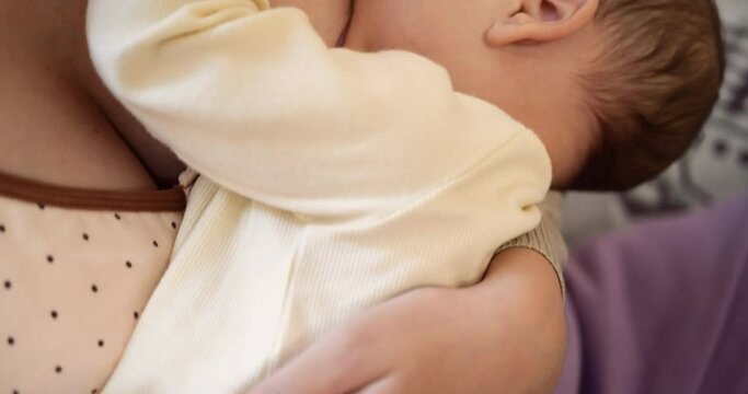 Woman breastfeeding newborn baby. Baby eating mother's milk. Concept of lactation infant