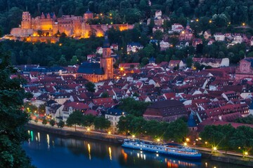Night time view over the rooftops of the Old Town of Heidelberg, Germany and the Neckar River
