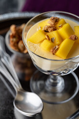 A close up of a mango mousse dessert parfait ready for eating.