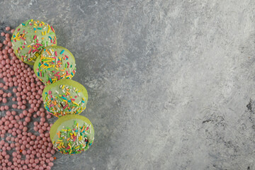 Green sweet doughnuts with sprinkles