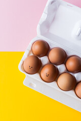 happy easter basket box of eggs with cheerful smiling faces on them. copy space top view flat lay. Easter weekend holiday concept. minimalistic abstract background greeting card banner