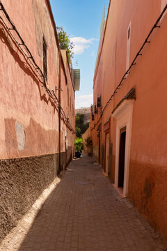 Empty narrow lane in medina of Marrakech city, Morocco. Traditional architecture for old town in North Africa.