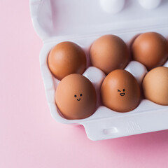 happy easter box of eggs with cheerful happy smiling faces on them. minimalistic trendy easter concept. copy space top view flat lay. minimalistic abstract background greeting card banner