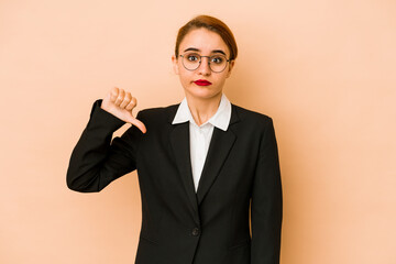 Young skinny caucasian business woman isolated showing a dislike gesture, thumbs down. Disagreement...