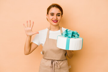 Young skinny arab pastry chef woman smiling cheerful showing number five with fingers.