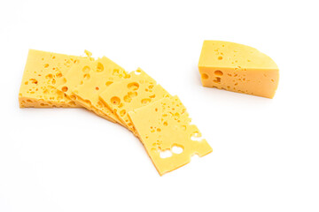 Appetizing cheese with holes cut into slices on a white background